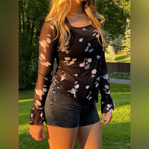 Black mesh top with flared out cuffs. - Picture 1 of 4